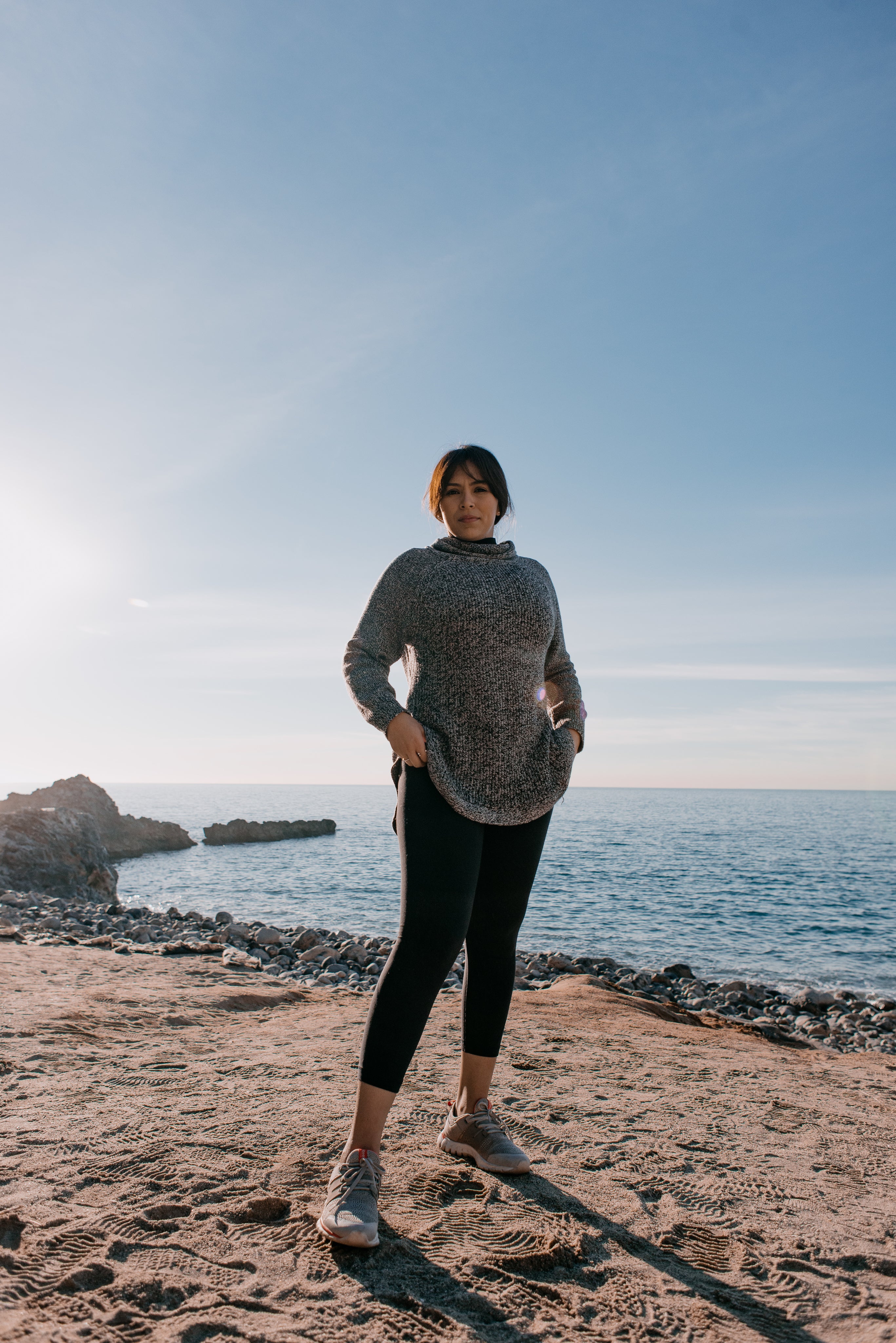 files/woman-in-sports-clothes-stands-on-a-beach-in-the-morning-light.jpg